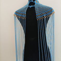 a mannequin is covered with blue chains and fringes on it's head