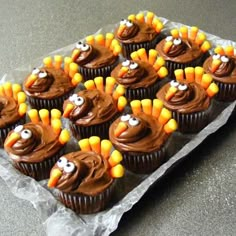 cupcakes with chocolate frosting decorated like turkeys