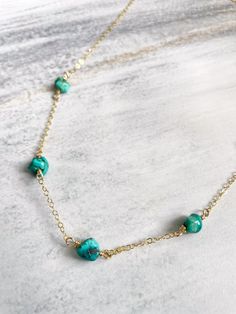 Introducing our stunning Turquoise Nugget Choker Necklace, exuding free-spirited, carefree vibes in every detail. Handcrafted to perfection, this 15-inch beauty features genuine turquoise nuggets, set approximately one inch apart on an 14kt gold filled chain. Perfect for adding a pop of color to any outfit, this necklace is a must-have for the free-spirited soul. Order now and let your adventurous spirit shine! Turquoise Choker Necklace, Beaded Turquoise Choker For Gift, Trendy Adjustable Turquoise Choker, Handmade Adjustable Turquoise Choker, Dainty 14k Gold-filled Turquoise Jewelry, Turquoise Nugget Necklace, Turquoise Choker, Genuine Turquoise, Free Spirit