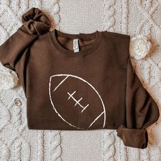 Stay warm and show off your team spirit with this Football-Inspired Sweater. Crafted with care, it features a bold football design on the front, making it perfect for game days or cozy nights at home. Made from soft, durable materials, this unisex sweater offers comfort and style in one. Available in multiple sizes, it's a versatile addition to any wardrobe. Get yours today and score a fashion touchdown! Funny Football Shirts, Womens Football Shirts, Game Day Sweatshirt, Halloween Tee Shirts, Fall Sweaters For Women, Football Sweater, Pumpkin Spice Shirt, Vintage Football Shirts, Retro Football Shirts