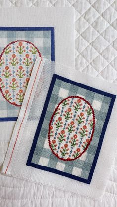 two cross - stitch designs are on top of each other, one is blue and the other is white