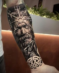 a man's arm with an image of the god and his cross on it