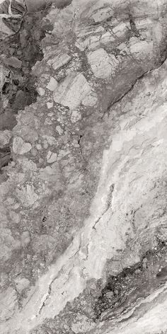 a black and white photo of rocks with some water in the middle one is very close to the ground