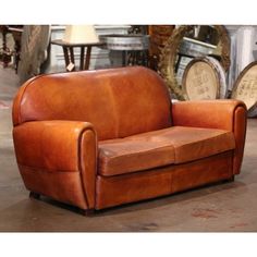 a brown leather couch sitting on top of a floor