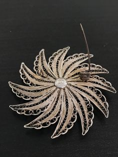 This stunning floral brooch has incredible detail on the silver work. This is all hand done and very time consuming! It has a double flower design and was handcrafted. This is made in 800 silver. Antique Sterling Silver Brooches For Wedding, Traditional Silver Brooches For Formal Occasions, Unique Wedding Brooches With Intricate Design, Traditional Handmade Brooch For Formal Occasions, Handmade Silver Brooches For Formal Occasions, Silver Handmade Brooches For Formal Occasions, Handmade Traditional Brooch For Formal Occasions, Unique Filigree Brooch For Wedding, Unique Filigree Brooches For Wedding