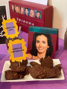 brownies are on a plate with some pictures in front of them and an album