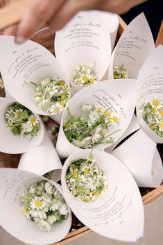 a basket filled with lots of white paper flowers