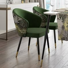 a dining room table with two green chairs