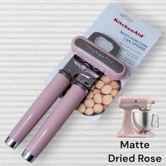 the kitchen aid matte - dried rose mixer is in its packaging next to it's attachment