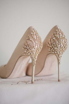 the bride's shoes are adorned with pearls