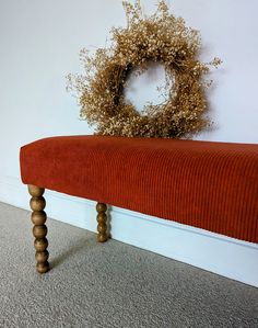 an orange bench with a wreath on it