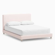 a pink bed with white sheets and pillows