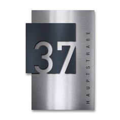 a stainless steel sign with the number 377 and it's name on it