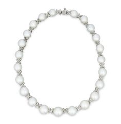 This classic necklace is the epitome of timeless elegance, with 23 exquisite South Sea pearls artfully interspersed with diamond-encrusted criss-cross motifs. South Sea pearls are among the largest and most coveted pearls in the world, and the examples in this exquisite strand necklace can be counted among the finest of their kind. The perfectly matched, graduated gems measure 10.5mm to 13.5mm, and each exhibits an exceptional luster. For added brilliance, 199 white brilliant cut diamonds, total Pearl Oyster, Rare Pearls, Pearl And Diamond Necklace, Oyster Pearl, Diamond Choker, Classic Necklace, Sea Pearl, Sea Pearls, South Sea Pearls