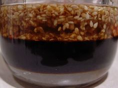 a glass jar filled with brown liquid on top of a table