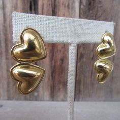 "90s gold tone chunky double heart stud statement earrings. They have a nice weight to them, but are not super heavy--one weighs the equivalent of three dimes.  They are 1-3/8\" x 3/4\" Nice and bright with no real flaws." Vintage Gold Double Heart Earrings, Gold Double Heart Vintage Earrings, Vintage Gold Heart Earrings For Valentine's Day, Vintage Double Heart Pierced Earrings, Retro Gold Heart-shaped Earrings, Vintage Double Heart Earrings, 90s Earrings, Puffed Heart, Minimalist Gifts