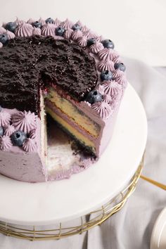 a blueberry cake with one slice cut out