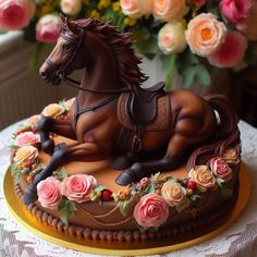 there is a cake with a horse on it and flowers in the backround