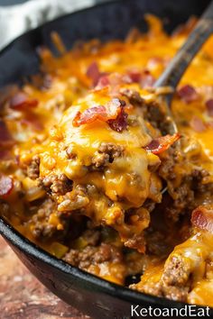 a close up of a casserole dish with meat and cheese on it, ready to be eaten