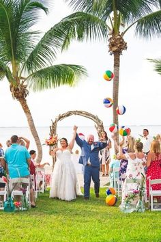 a newly married couple walking down the aisle to their wedding ceremony at an oceanfront resort