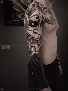 a man with tattoos on his arm and shoulder