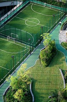 an aerial view of a soccer field in the middle of a park with green grass