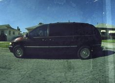 a black van parked in front of a house