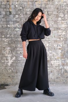 High waisted trousers with extra wide straight legs and 2 pockets. Flat front waist band with elastic at the back and belt loops Color: Black and Navy  Size suggestion:  S: waist 78cm/ length 97cm M: waist 82cm/ length 99cm  L: waist 86cm/ length 101cm Male Model:  179cm 75kg, wearing size M/L Female Model:  163cm 63kg, wearing size M/L Fabric: 92/8 cotton/polyester Chic Baggy Wide Leg Parachute Pants, Solid Wide Leg Parachute Pants For Work, Solid Color Wide Leg Parachute Pants For Work, High-waisted Loose Fit Culottes With Pockets, High-waisted Wide Leg Pants, Loosely Fitted High-waisted Culottes With Pockets, High-waisted Wide Leg Pants With Side Pockets, Chic Wide-leg Parachute Pants With Elastic Waistband, Wide Leg Relaxed Fit Harem Pants For Work