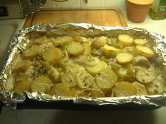 potatoes and onions are cooked in foil on the kitchen counter