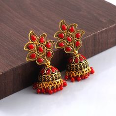 Overview These stylish Jhumki Earrings set from JewelryTrack will certainly leave you spellbound. These Jhumki Earrings set have an excellent finish and gives out an exquisite sense of style. If you are looking for an amazing Fashion Jewelry set for special occasions such as Anniversary, Engagement, Party, Wedding or for gifting , then your search ends here.  Item Description: The look is stunning and preciously suitable for all kinds of dressy occasions. Metal: Brass OCCASION: PARTY WEAR , WEDD Red Earrings For Puja And Festivals, Red Temple Jewelry Earrings For Navratri, Red Jewelry With Latkans For Eid, Red Earrings For Puja And Diwali, Red Meenakari Earrings For Puja, Red Temple Jewelry Chandbalis For Diwali, Temple Jewelry Red Chandbalis Drop Earrings, Red Chandbali Danglers In Temple Jewelry Style, Traditional Red Chandbalis Drop Earrings