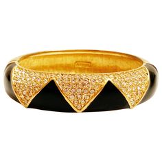 - Vintage item - Measures 3" x 2.5" - Fits small to medium sized wrists - Gold plated - Black enamel detail - Swarovski crystals - Opens on a hinge - Hidden push clasp - By Daniel Swarovski (signed on interior) - Circa 1980s - Estate acquired - This item has been cleaned & polished and is ready to wear - Excellent vintage condition Diamond Cuff Bracelet, Vintage Cuff Bracelet, Hinged Bangle, Vintage Chanel, Black Enamel, Bangle Bracelet, Hinges, Givenchy, Cuff Bracelets