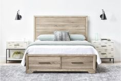 a bed with two nightstands next to it and a white wall in the background