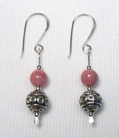 These earrings are Sterling Silver wth 6 mm Rhodonite stones and 8 mm pewter patterened beads. Their overall length including earwires is about 1 1/2". Handmade by us. The pair shown is the one you will receive.   Lyn's Jewelry, in business operating out of Sunny Syracuse since 1989. A family owned and operated business. Check us out! Artisan Jewelry Earrings, Wire Wrapped Jewelry Tutorials, Drop Earrings Silver, Wire Jewelry Tutorial, Business Check, Handcrafted Artisan Jewelry, Wrapped Jewelry, Earring Patterns, Fun Diy