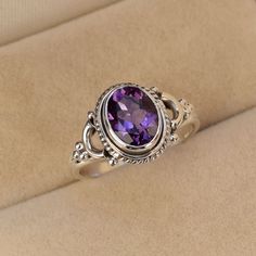 This Ring is handcrafted in Solid 925 Sterling Silver with Natural Amethyst gemstone, It is free from lead and nickel to prevent from any type of skin allergies. Product: Ring Metal/Material: 925 Silver Gemstone: Amethyst Stone Type: Cut stone Stone size: 7x9 mm approx. Stone shape: Oval Weight: 4 gram approx. Birthstone: February Ring Sizes: 5 to 12 US. Select on drop down Stone Setting: Bezel Stone Color: Purple Finishing: Shiny silver Gemstone Properties: Amethyst: Amethyst is a protective st Sterling Silver Purple Center Stone Gemstones, Sterling Silver Gemstones With Purple Center Stone, Sterling Silver Hallmarked Amethyst Promise Ring, Purple Amethyst Ring Stamped 925 For Promise, Purple Amethyst Promise Ring Stamped 925, Hallmarked Sterling Silver Purple Amethyst Ring, Hallmarked Purple Amethyst Sterling Silver Ring, Stamped 925 Amethyst Ring Fine Jewelry, Hallmarked Sterling Silver Amethyst Ring