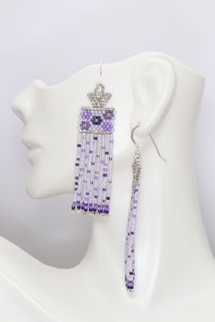 Swoon worthy sweet lavender, purple, and silver boho seed bead earrings featuring a dainty flower pattern with confetti on the swaying fringe. They were inspired by a beautiful bouquet I saw, and I wanted to share that beauty and the happiness the colors brought me with you. These are OOAK. Handmade by me in my home studio.Size 2 7/8 inches long5/8 inch wide2 1/4 inch drop Purple Beaded Fringe Earrings As Gift, Elegant Lavender Beaded Earrings, Purple Beaded Fringe Drop Earrings, Purple Beaded Fringe Earrings For Gift, Purple Jewelry With Beaded Fringe And Round Beads, Elegant Lavender Beaded Earrings With Dangling Beads, Bohemian Lavender Beaded Dangle Earrings, Lavender Beaded Dangle Earrings, Lavender Adjustable Dangle Beaded Earrings