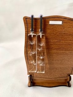 a wooden clock with dandelions attached to it