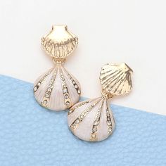 Enamel and Rhinestone Seashell Dangle Earrings "The perfect combination of summer vibes and shiny bling, these earrings will make you stand out like a pearl in an oyster! You'll be the talk of the beach (and beyond) with these enamel and rhinestone seashell dangle earrings. Say goodbye to boring accessories and hello t Elegant Beach Season Jewelry, Elegant Shell-shaped Earrings For Vacation, Elegant Shell Jewelry For Beach Season, Elegant Silver Jewelry For Beach Season, Elegant White Jewelry For Beach Season, Silver Shell-shaped Earrings For Summer, Scarf Coverup, Rebecca Black, Kids Scarf