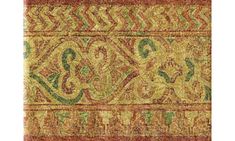 an intricately designed rug with red, green and yellow colors on the bottom half