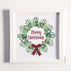 a handprinted christmas wreath with the words merry christmas in red, green and white