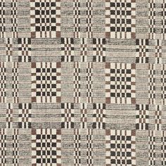 a black and white checkered rug with brown squares on the bottom, in different colors