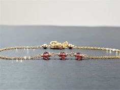 This beautiful handmade bracelet features 3 Genuine Garnets wrapped in 14k Gold Filled or Sterling Silver. Dainty, minimal, and elegant, this bracelet is the perfect finishing touch to any style or event. Wear this beautiful handmade bracelet alone or stacked with others. Makes a great gift to add to any gemstone lover's collection. Perfect to gift for Christmas, Valentine's Day, Mother's Day, and more! Gemstone: Garnet Bead Size: 3.0 mm Gemstone Shape: Rondelle, Faceted Metal: 14k Gold Filled o Dainty Handmade Formal Bracelets, Dainty Handmade Bracelets For Formal Occasions, Handmade Dainty Bracelets For Formal Occasions, Elegant Handmade 14k Gold Filled Bracelets, Elegant Handmade Rose Gold Chain Bracelet, Elegant Handmade 14k Gold-filled Bracelets, Handmade Minimalist Gold Bracelet As Gift, Elegant 14k Gold Filled Hand-wrapped Bracelets, Handmade Elegant 14k Gold Filled Bracelets