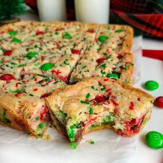 a close up of a cake on a plate with candy canes and milk in the background