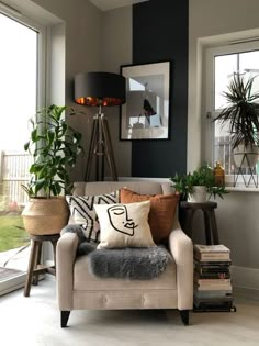 a living room filled with furniture and lots of plants