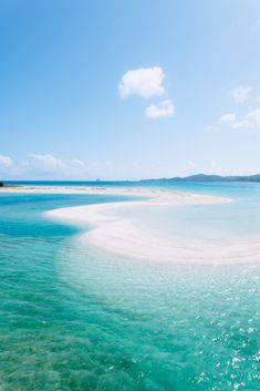 the water is very clear and blue with some white sand in it's foreground