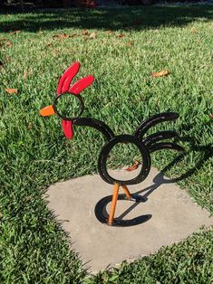 a sculpture in the shape of mickey mouse's head on top of a patch of cement