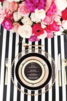 an image of a table setting with flowers on the plate and place settings below it