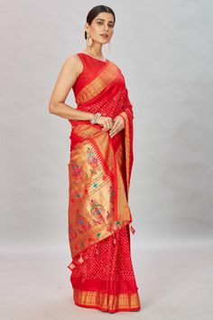 Look royal at weddings and special occasions in this stunning red bandhani kanchipuram saree with Paithani pallu. It comes with a blouse piece. Disclaimer: The shown stitched blouse on the model is for display purpose only. The saree comes with a matching blouse piece and finished with fall and piko. Red Traditional Pre-draped Saree For Transitional Season, Red Pre-draped Saree For Transitional Season, Red Bandhani Print Pre-draped Saree In Art Silk, Red Art Silk Pre-draped Saree With Self Design, Festive Red Pre-draped Saree With Bandhani Print, Red Bandhani Pre-draped Saree, Traditional Red Pre-draped Saree With Zari Weaving, Festive Red Pre-draped Saree With Pallu, Red Bandhani Print Unstitched Saree