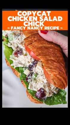 a chicken salad sandwich with lettuce, tomatoes and cranberries on it