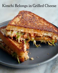 a grilled cheese sandwich sitting on top of a blue plate