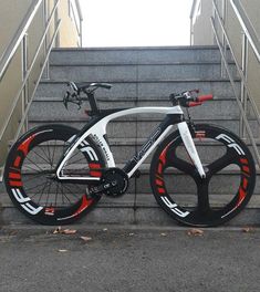 a white and red bike parked on some steps